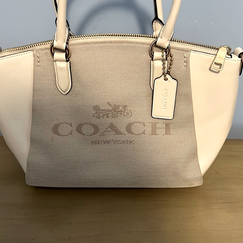 nice bag from macys brand is coach white coming with too indol  slam size